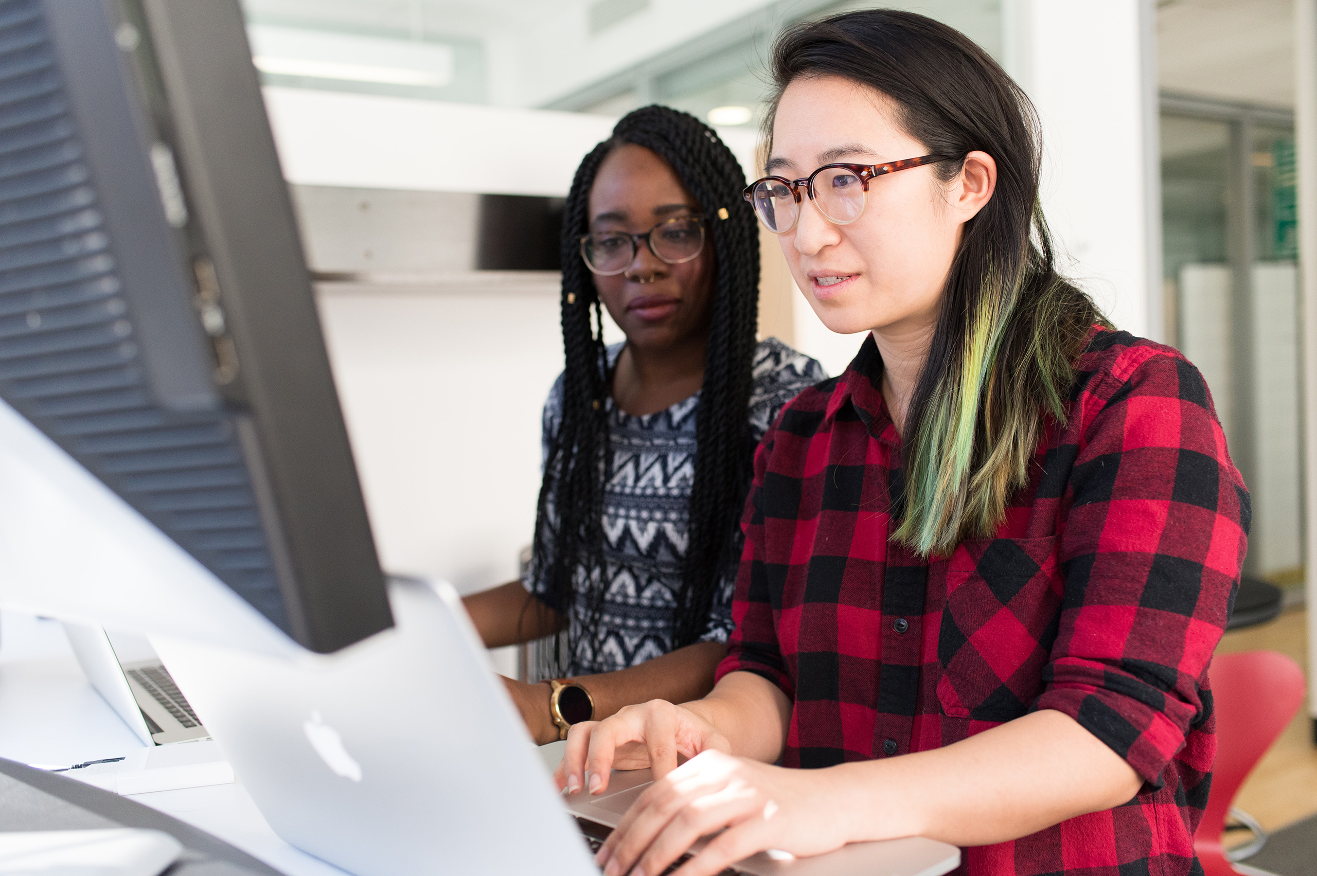 christina-wocintechchat-com-RMweULmCYxM-unsplash Two women look at a computer screen